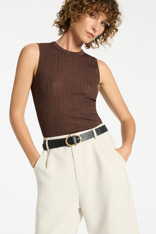 woman wearing black leather belt with gold buckle