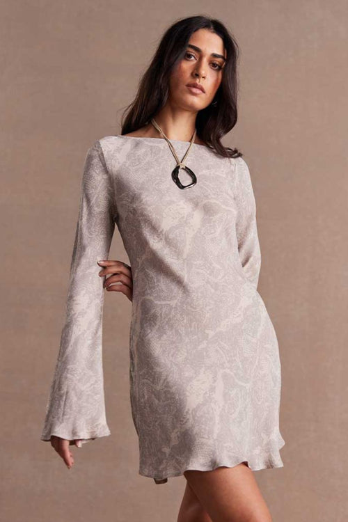 model wears a grey long sleeve dress