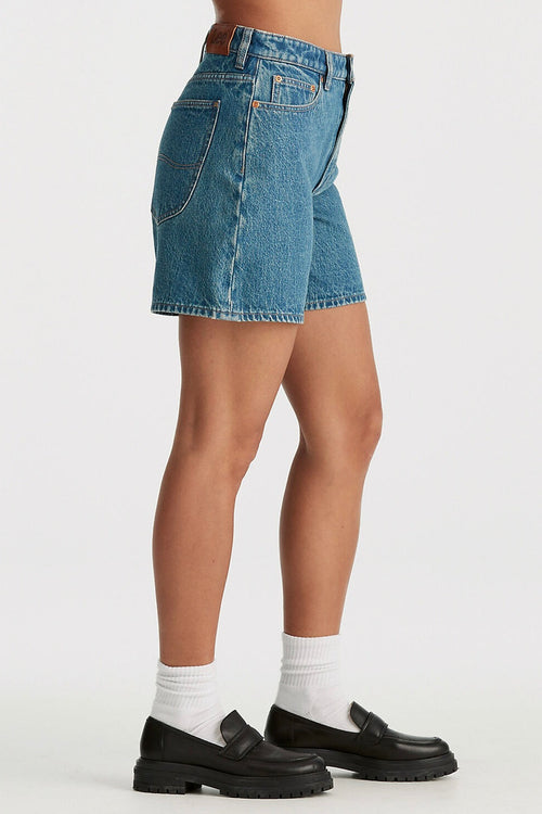 model wears blue denim shorts