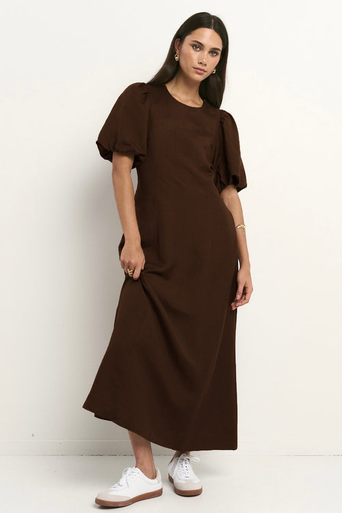 model wears a brown midi linen dress