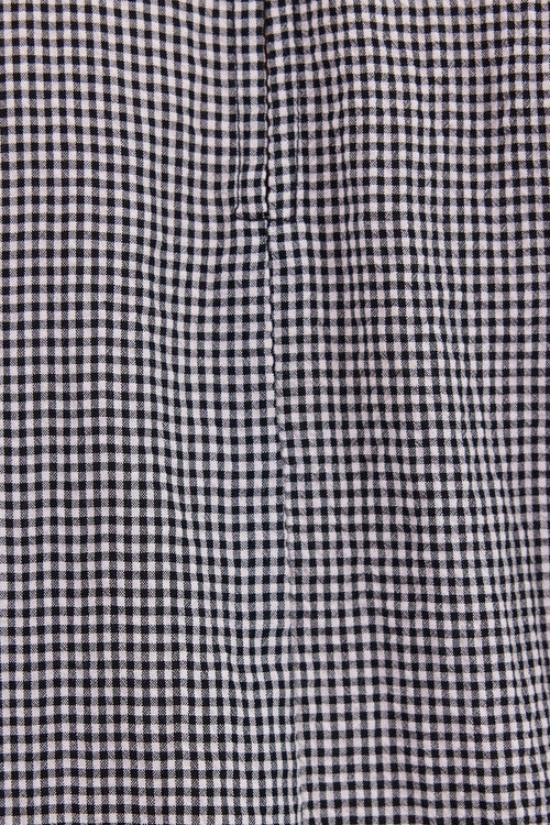 Close-up of a black and white gingham checkered fabric texture.
