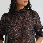 model wears a black floral blouse