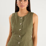 the model wears a green linen vest with a white maxi skirt
col_pattern