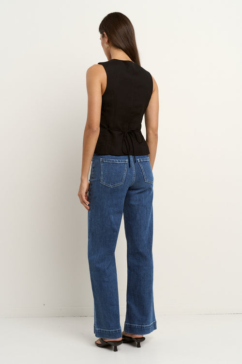 model wearing black linen vest