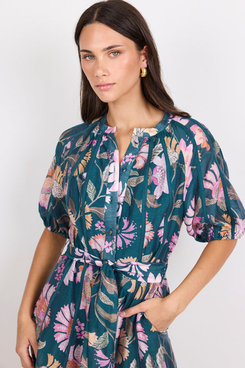 Woman wearing a floral dress with a white background