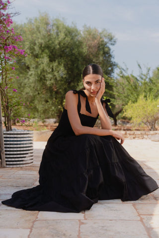 model wears a black strappy maxi dress