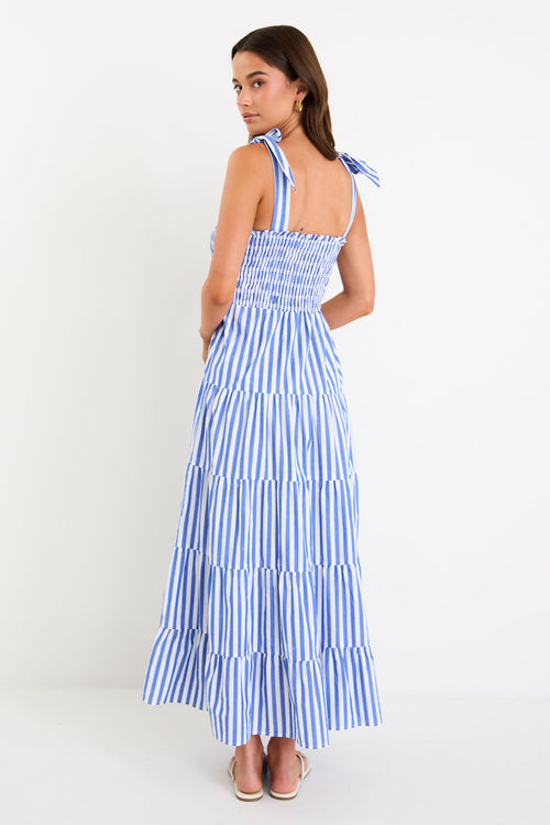 Woman wears a blue white striped maxi dress