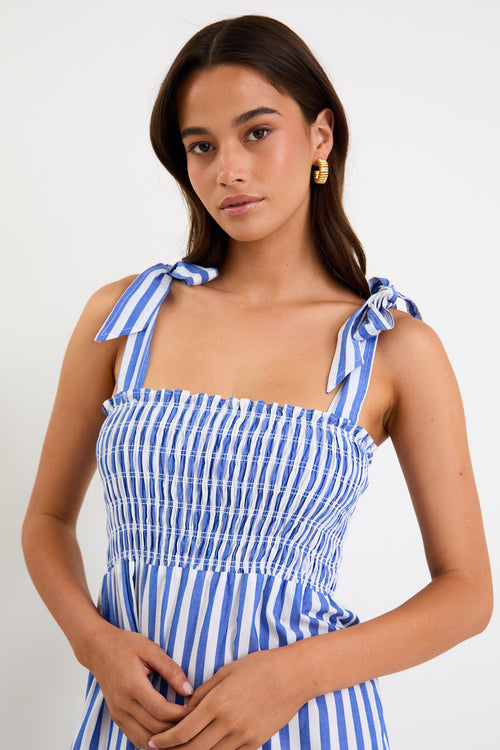 Woman wears a blue white striped maxi dress