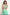 Woman wears a green and white striped maxi dress