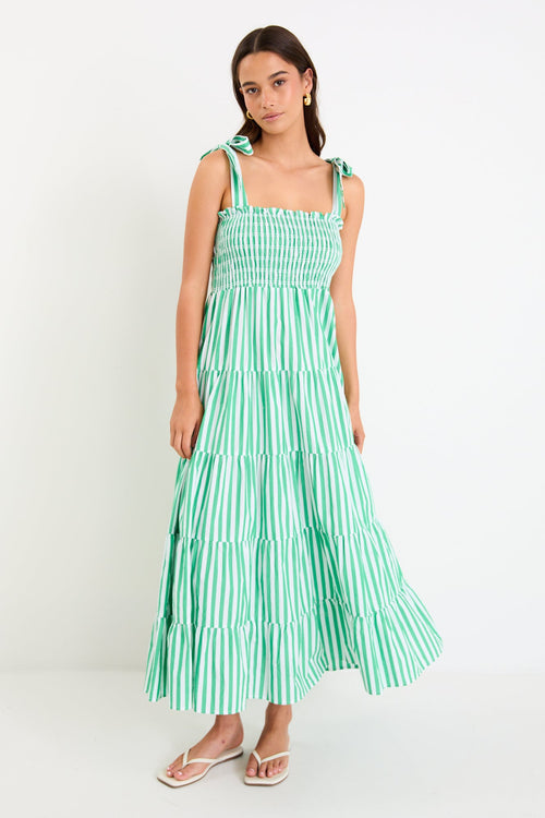 Woman wears a green and white striped maxi dress