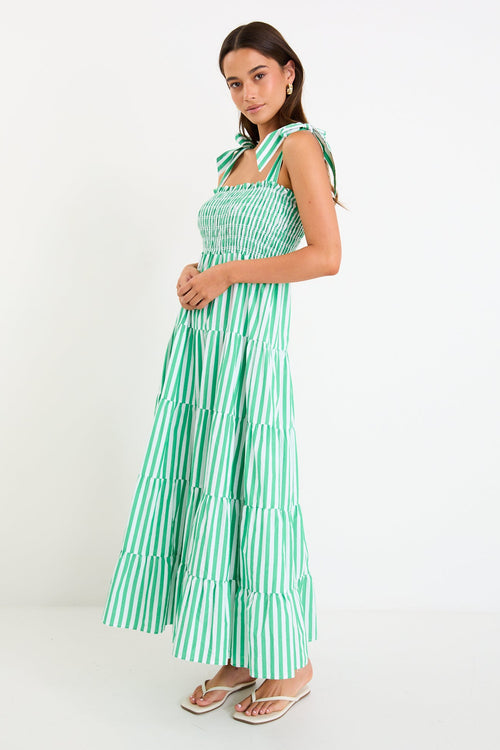 Woman wears a green and white striped maxi dress