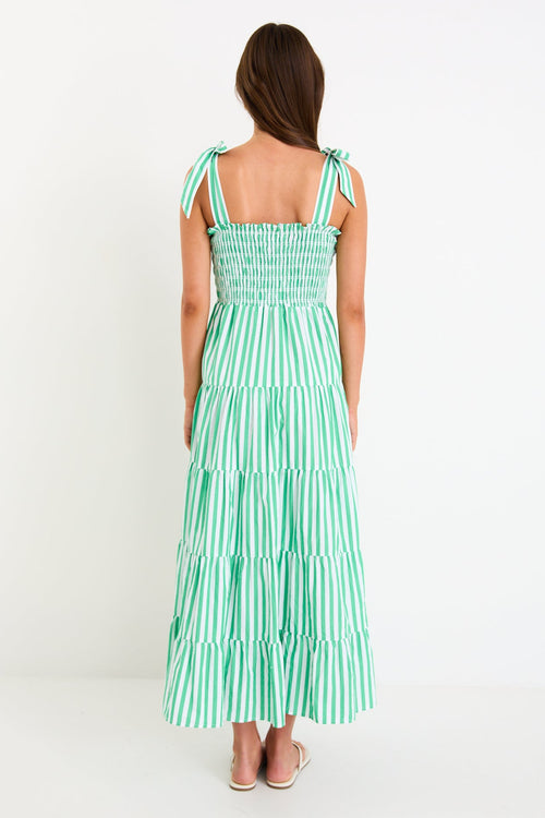 Woman wears a green and white striped maxi dress