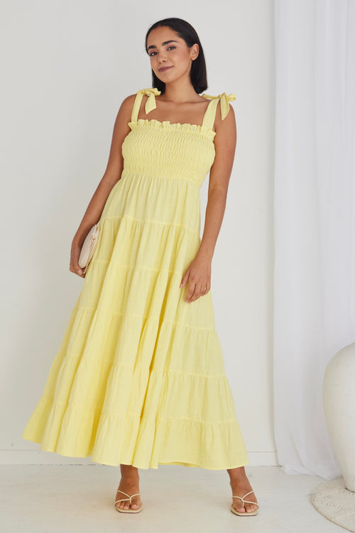 model wearing long yellow maxi dress and heels