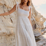 model wears a white strappy maxi dress