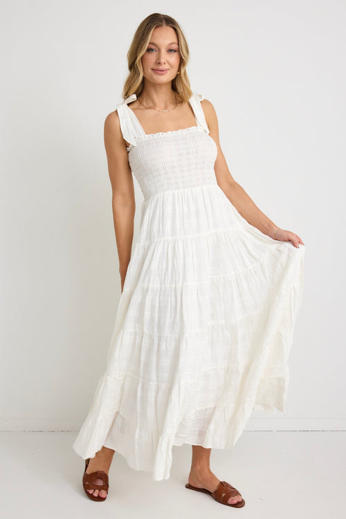 model wears a white strappy maxi dress