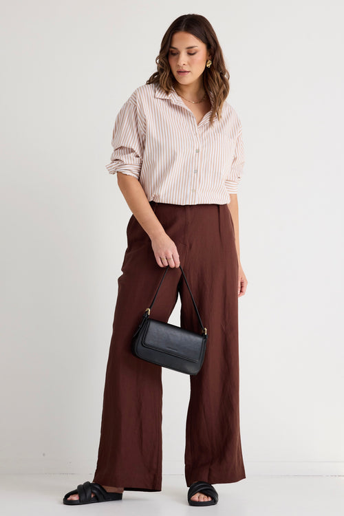 model wears brown linen pants