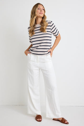 model wears white linen pants