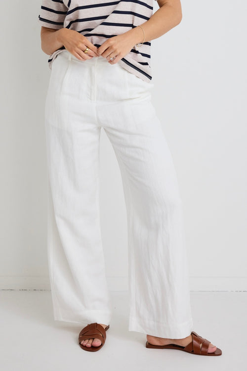 model wears white linen pants