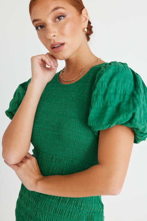 model wears a green maxi dress