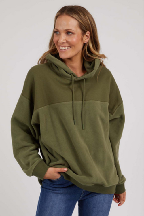 woman wearing green hoodie and blue jeans