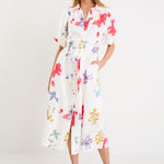 Model wearing a cream midi shirt dress with colourful poppy floral print, puff sleeves and a waist tie.