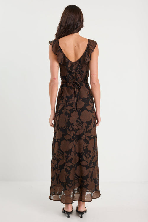 Woman wearing a black floral lace dress on a white background