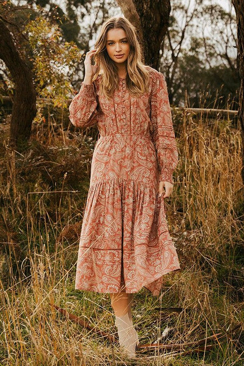 model wears a brown print dress