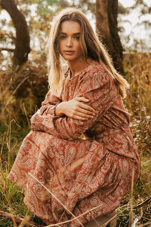 model wears a brown print dress