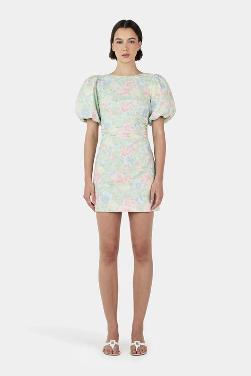 Woman wearing a green floral mini dress