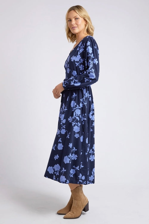 model wears a blue long sleeve floral dress