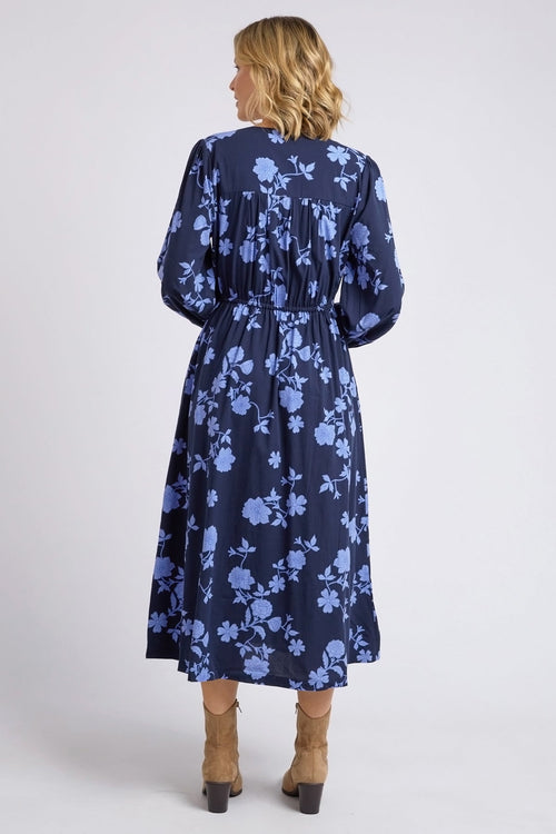 model wears a blue long sleeve floral dress