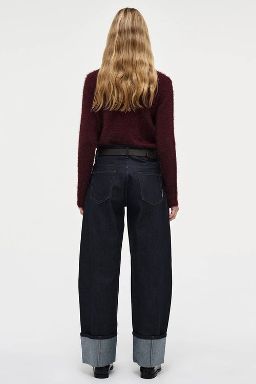 Model wears Burgundy long sleeve knit jumper