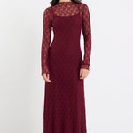 Woman wearing a burgundy lace dress on a white background