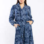 model wears a blue paisley pattern shirt style dress