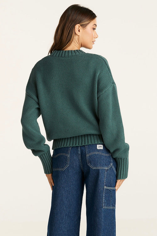 Model wears a Green Knit Sweater 