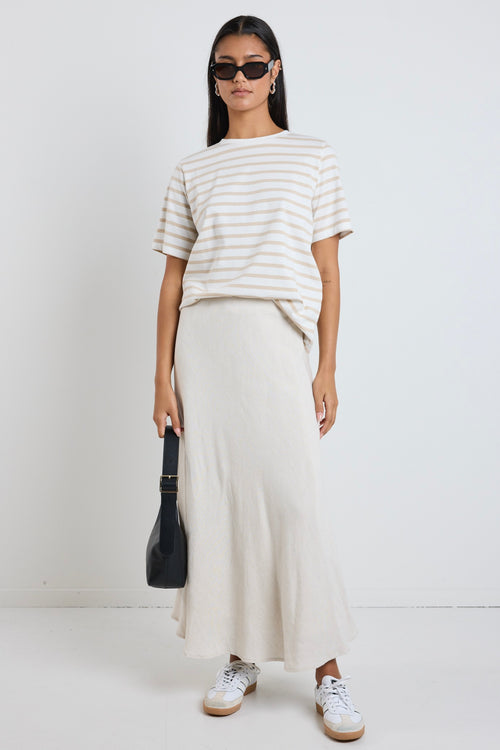 Model wears a beige linen maxi skirt