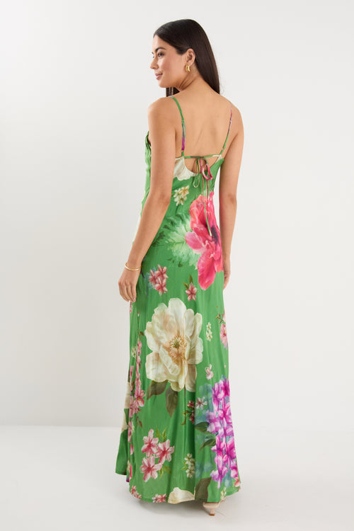 model wears a green floral maxi dress