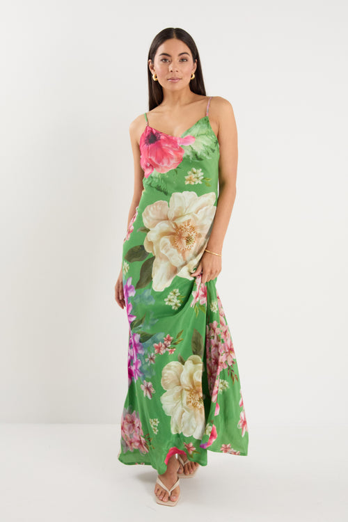 model wears a green floral maxi dress