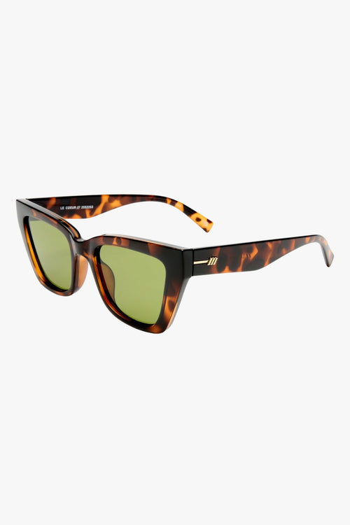 Dark tortoiseshell cat-eye sunglasses with angular frames and moss green lenses