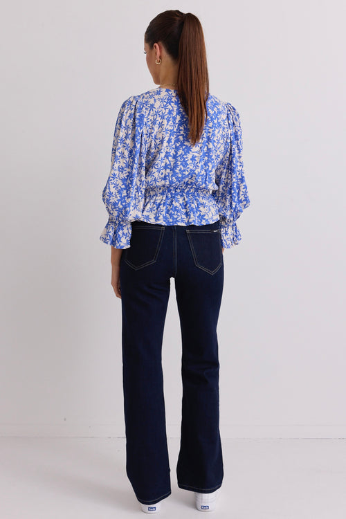 model wears a blue floral top