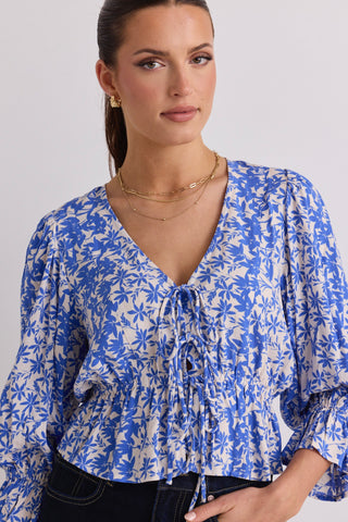 model wears a blue floral top