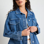 Model wears a blue denim jacket 