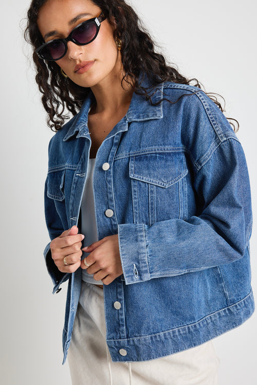 Model wears a blue denim jacket 