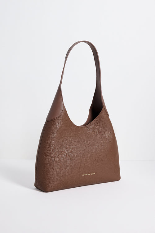 Brown leather handbag on a white background