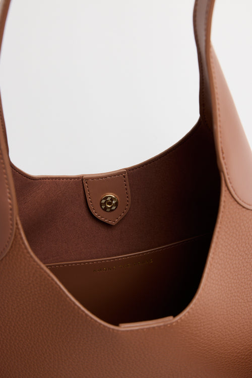 Brown leather handbag on a white background