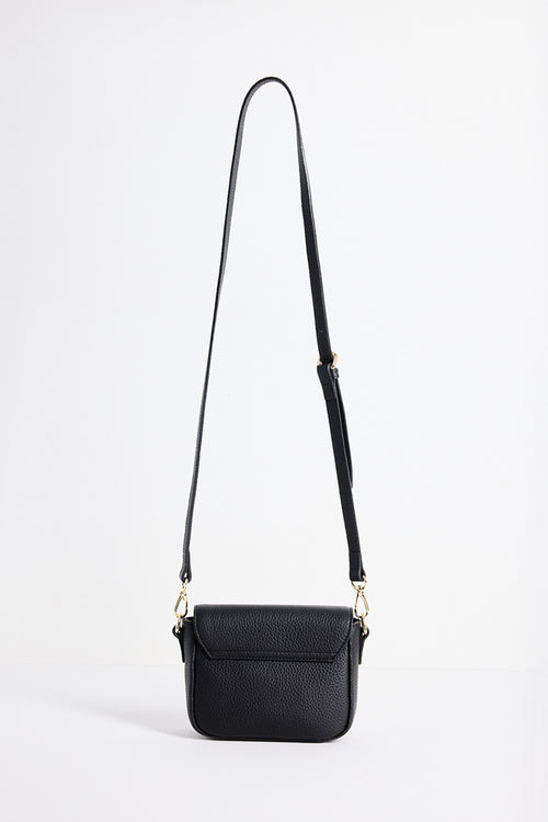 A black pebbled leather crossbody bag with a long adjustable shoulder strap and gold-tone hardware, shown against a plain white studio background.