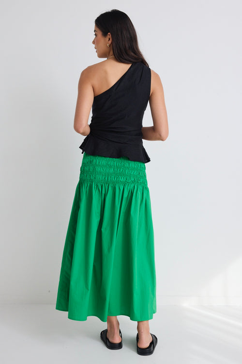 model wears a green poplin skirt