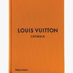Orange book with 'Louis Vuitton Catwalk' text on a white background
