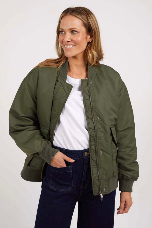 model wears a green bomber jacket