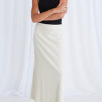 model wears a beige rib knit maxi skirt